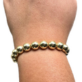 Pulsera de cuentas doradas gruesas