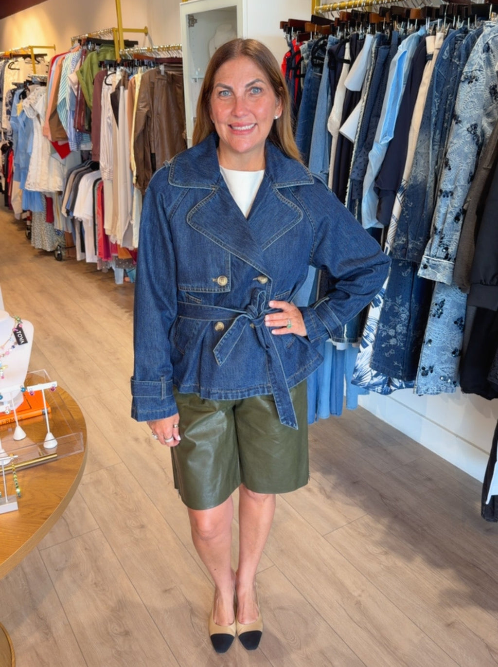 Woman wearing The Riviera double-breasted blue denim jacket with waist belt PS Showroom