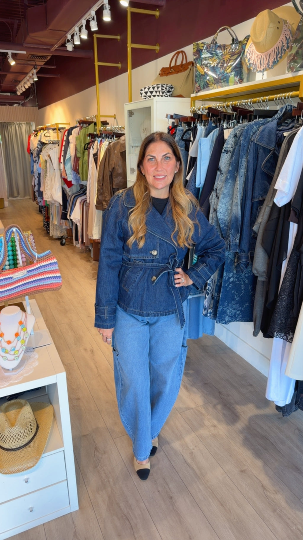 Woman wearing The Riviera double-breasted blue denim jacket with waist belt PS Showroom