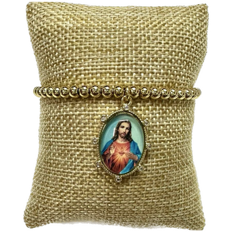 Pulsera dorada con medalla religiosa